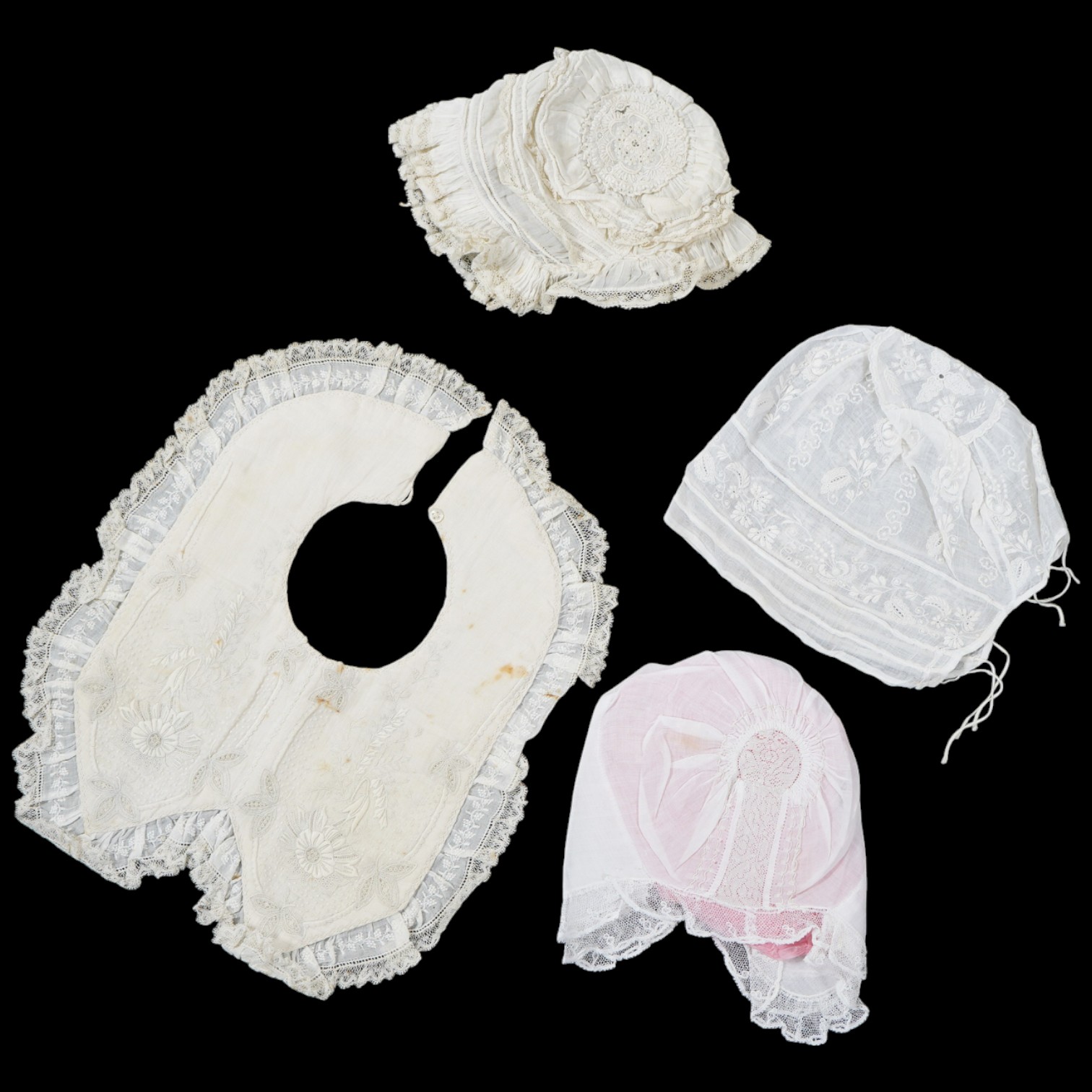 An 18th century Holly Point needle lace panelled linen baby bonnet, an early 19th century white worked baby bib and bonnet and a later 19th century finely ruffed lace bonnet (4). Condition - Holly Point bonnet and bib ha